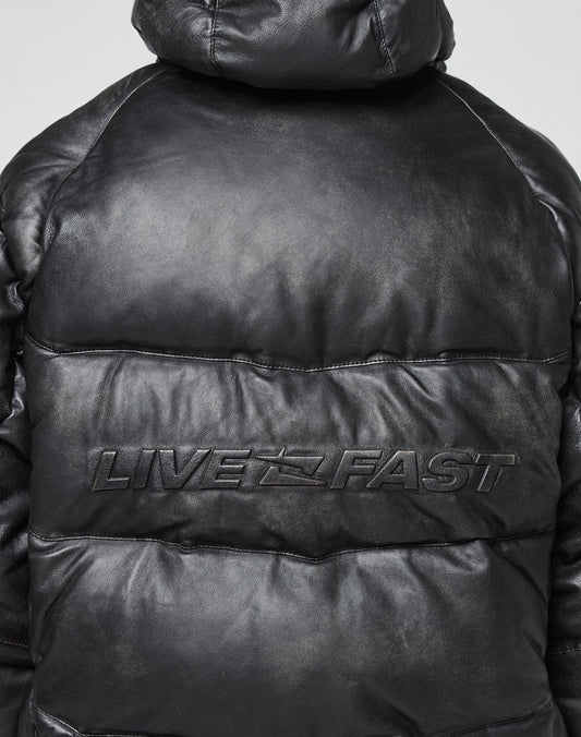 A close-up of the back of the black Live Fast Leather Puffer Jacket by LIVE FAST DIE YOUNG, featuring an oversize fit and an embossed Live Fast Logo across the upper back.