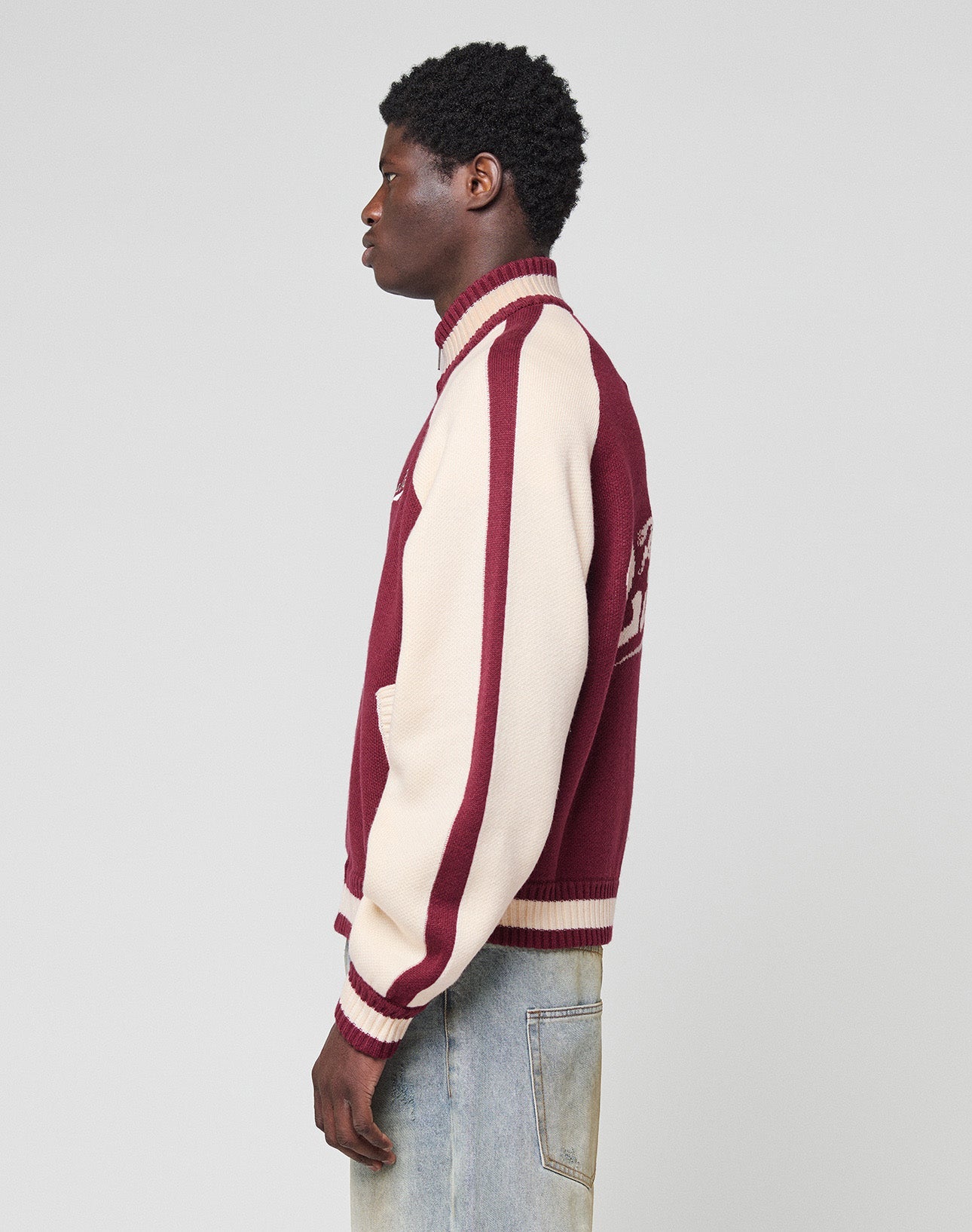 A person wearing the LIVE FAST DIE YOUNG Boxy Knit Zip Jacket with an oversized fit stands against a plain light background, photographed from behind.| model