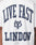 The Live Fast London Tee by LIVE FAST DIE YOUNG is a white, 100% Baumwolle T-shirt with bold navy LIVE FAST LONDON text and a central logo. It features an oversize fit, small LFDY text near the hem, and the image highlights the back.