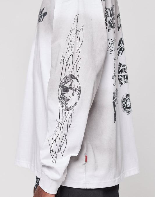 A person in the LFDY Logo Longsleeve by LIVE FAST DIE YOUNG, an oversized white 100% Baumwolle shirt with black abstract geometric and graphic designs on the chest and sleeve, shown from the side against a plain background.