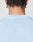 The back of a person’s head with braided hair, wearing the Live Fast College Tee by LIVE FAST DIE YOUNG in Oversize Fit. Small white text near the collar reads, “I’M JUST A KID WITH A DREAM.”.