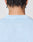 The back of a person’s head with braided hair, wearing the Live Fast College Tee by LIVE FAST DIE YOUNG in Oversize Fit. Small white text near the collar reads, “I’M JUST A KID WITH A DREAM.”.