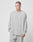 A person with short hair wears the LIVE FAST DIE YOUNG Basic Longsleeve and matching pants in light gray 100% Baumwolle, standing against a plain white background and looking slightly to the side.