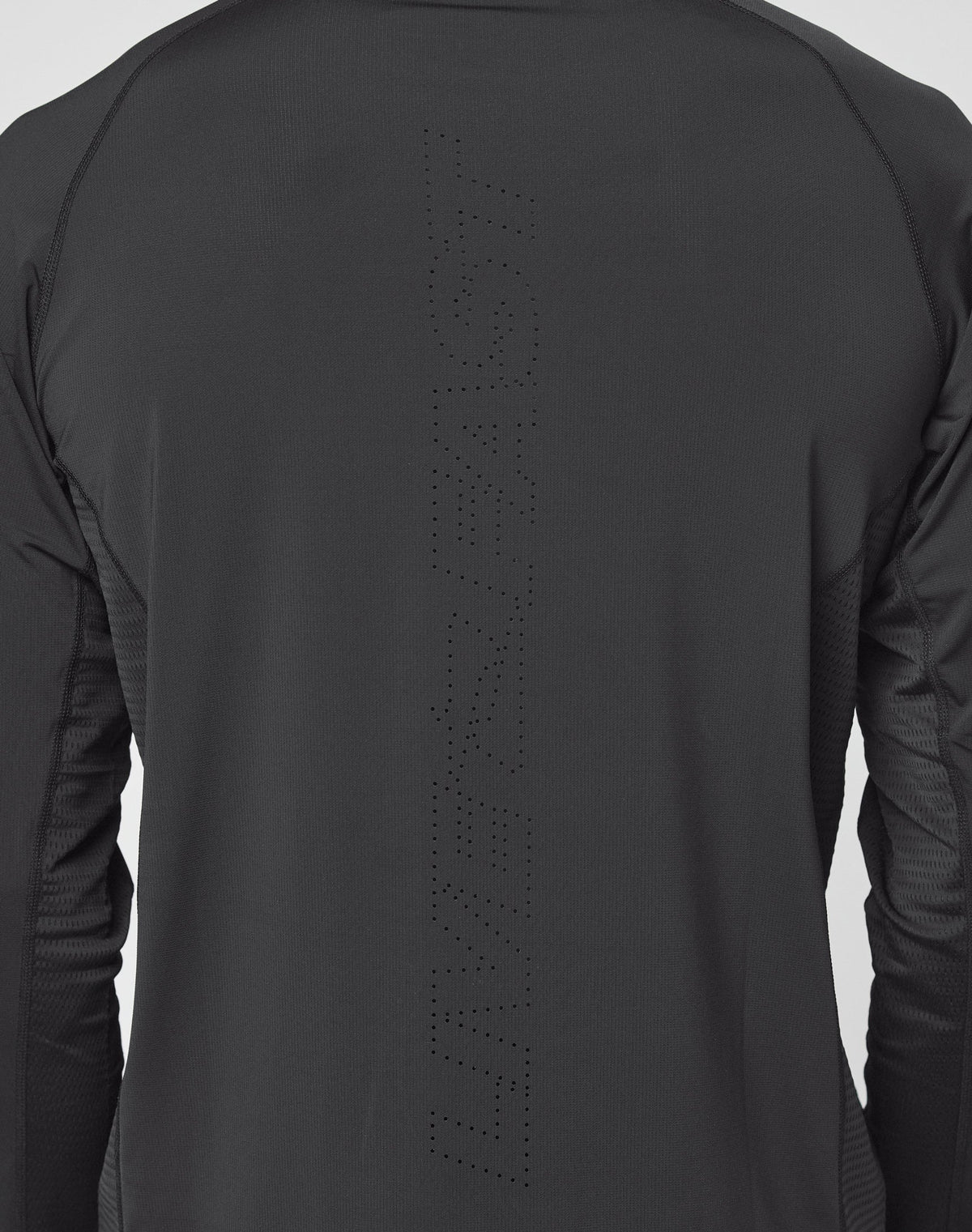 A close-up of the back of a black Live Fast Performance Longsleeve by LIVE FAST DIE YOUNG, featuring “LIVE FAST” subtly printed in small perforated dots down the center.