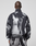 A person with closely shaved hair is seen from behind wearing a loose-fitting black and white LFDY Performance Jacket by LIVE FAST DIE YOUNG, along with matching pants featuring a reflective logo print, set against a plain gray background.
