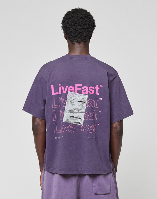 A person in a purple Basic Evidence Tee by LIVE FAST DIE YOUNG, made from 100% Baumwolle, featuring repeated “LiveFast” text and a graphic on the back. The front and back print design is shown from behind against a plain background. | model