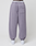 A person wearing the LFDY Hotline Loose Jogger by LIVE FAST DIE YOUNG in lavender with elastic waistband, single patch pocket, leg print, and white sneakers is seen from behind against a plain background.