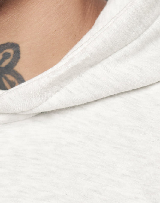 Close-up of a person in a white LIVE FAST DIE YOUNG Basic Hooded Zip, showing part of their neck and a black curved-line tattoo above the collar.
