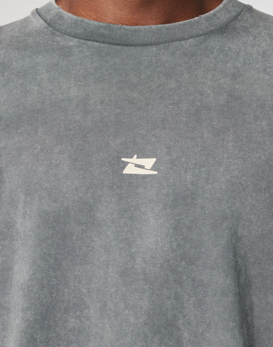 Close-up of a person wearing the LFDY Double Layered Longsleeve by LIVE FAST DIE YOUNG in faded gray, featuring a vintage wash and a small, minimalist white and beige logo at the center chest. Only the neck and upper chest are visible.