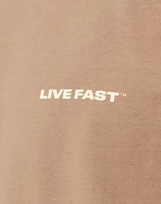 Close-up of the Live Fast Plain Tee by LIVE FAST DIE YOUNG, made from 100% brown cotton, featuring the text LIVE FAST™ as a bold white front print in capital letters.