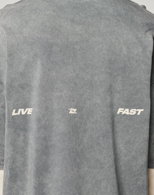 The LFDY Double Layered Longsleeve by LIVE FAST DIE YOUNG is a gray, vintage-wash tee with LIVE and FAST in white on the front, separated by a small abstract symbol.