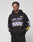 A person wears the LIVE FAST DIE YOUNG LFDY Racing Hooded black hoodie with glossy purple and yellow graphics that say LIVE FAST Everything in it, paired with matching black pants, against a plain light background.