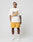 A man in sunglasses, yellow shorts, white crew socks and sneakers wears a LIVE FAST DIE YOUNG LFDY Adults Only Tee, standing against a plain light gray background.
