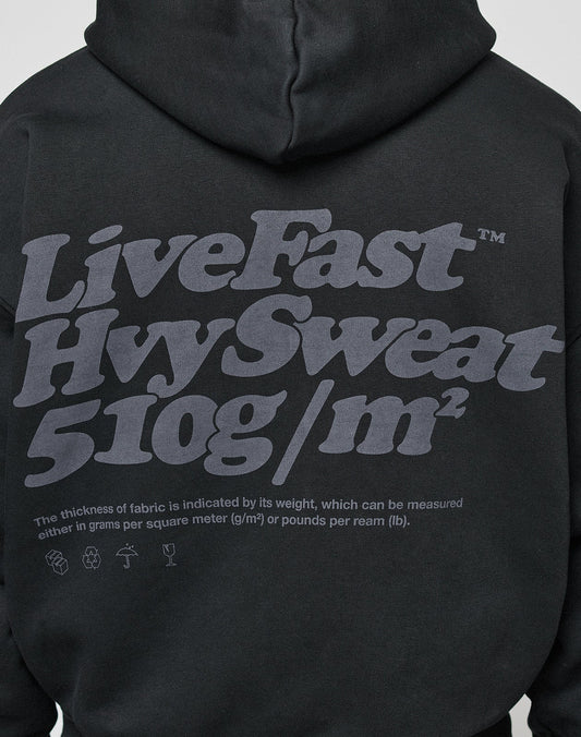 The LIVE FAST DIE YOUNG Basic 510 Hooded Zip is a black hoodie with bold gray “LiveFast HvySweat 510 gsm” text on the back, oversize fit, small text explaining fabric thickness, and detailed icons along the bottom.
