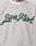 A person wears the LFDY Script Sweater by LIVE FAST DIE YOUNG, an oversize fit light gray sweatshirt with raglan sleeves and Live Fast in large green cursive on the front. A neck tattoo is visible above the collar.