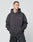 A man in an Oversize Fit LFDY Cinema Hooded by LIVE FAST DIE YOUNG, dark gray with LIVE FAST on the left chest, stands hands in pocket looking left against a light background. Cotton-poly blend ensures comfort and style.