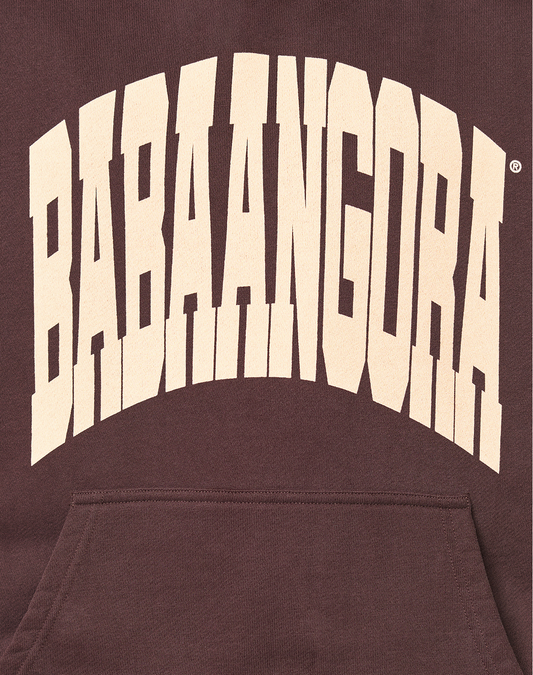 The image features the LFDY x Baba Angora Hoodie by LIVE FAST DIE YOUNG, displaying "BABAANGORA" in large, bold, cream arched letters on dark brown cotton fabric with an oversized fit and a visible front pocket.