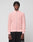 A man with short, textured hair wears the LIVE FAST DIE YOUNG LFDY Knit Jacket in light pink with ribbed texture and Stehkragen, paired with black pants, standing against a plain light gray background.