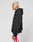A person with short blond hair wears an oversize fit LIVE FAST DIE YOUNG Basic 360 Hooded black hoodie and white shorts with red stripes, standing in profile against a plain white background. Subtle topstitching adds detail.