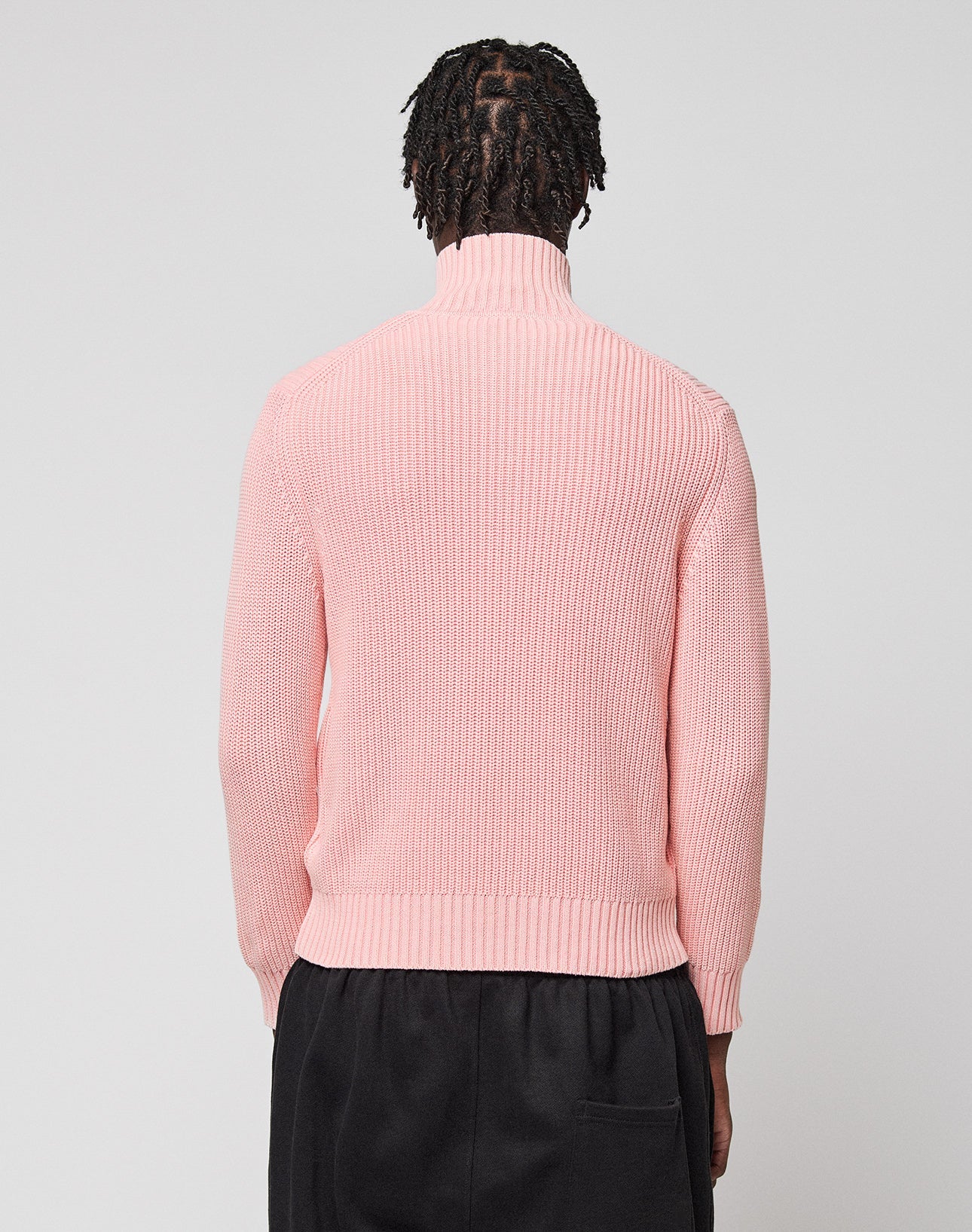 A person with short, twisted hair is shown from the back wearing the LIVE FAST DIE YOUNG LFDY Knit Jacket and black pants against a plain, light gray background.