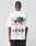 A person wears the LFDY Cinema Tee by LIVE FAST DIE YOUNG—an oversized white cotton T-shirt with a black-and-white face print, bold red LIVE FAST text, and detailed back design, photographed from behind on a plain background.