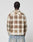 A person with braided hair, seen from behind, wears the LIVE FAST DIE YOUNG Faded Flannel in brown and cream plaid with light blue jeans, standing against a plain white background.
