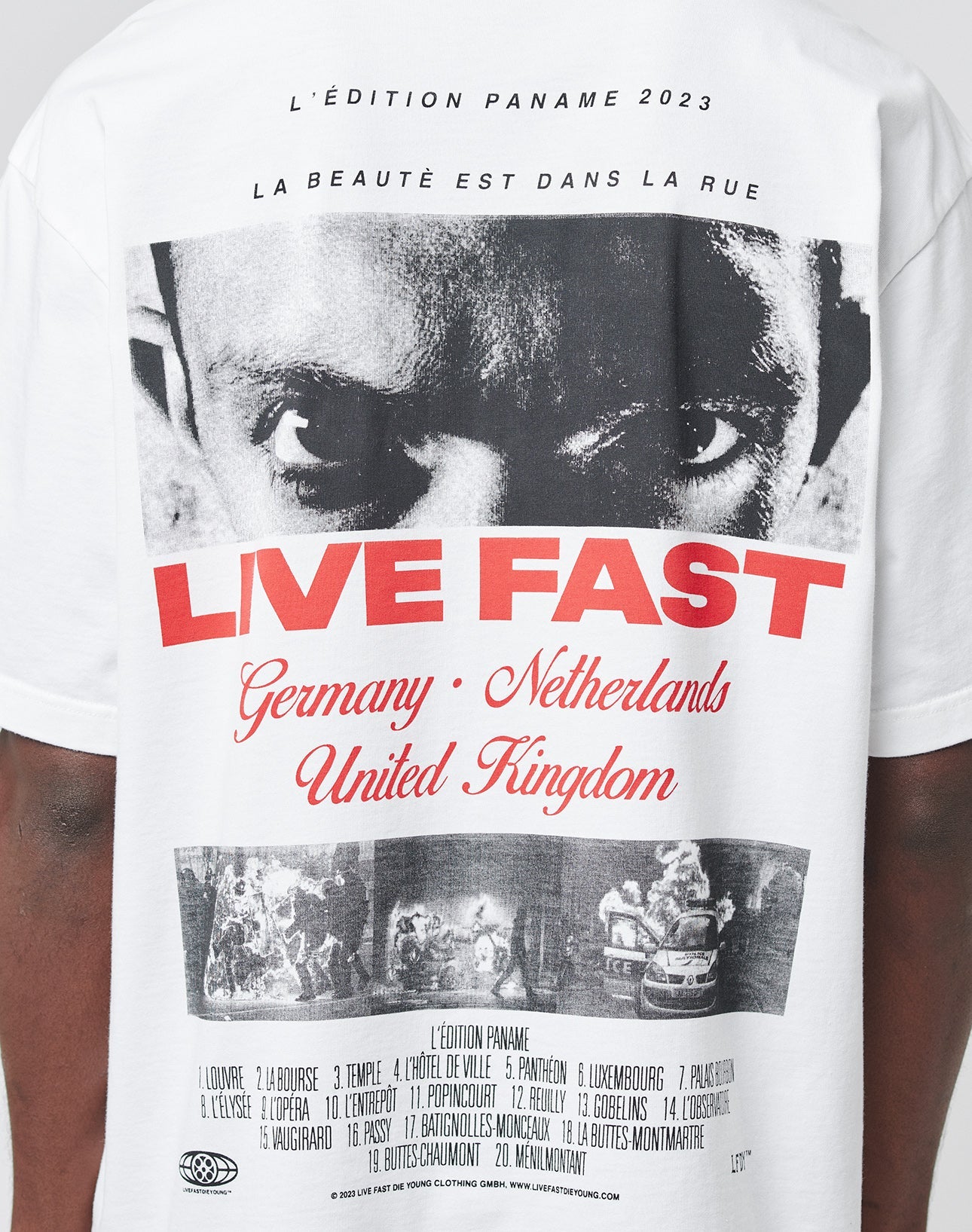 The LFDY Cinema Tee by LIVE FAST DIE YOUNG is a white, oversized 100% cotton T-shirt with bold LIVE FAST text, a black-and-white photo print of intense eyes, extra photos and small text on front and back, plus Germany, Netherlands, UK names.