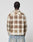 A person with braided hair, seen from behind, wears the LIVE FAST DIE YOUNG Faded Flannel in brown and cream plaid with light blue jeans, standing against a plain white background.