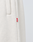 Close-up of LFDY Heavyweight Loungepants by LIVE FAST DIE YOUNG in light beige, featuring textured Baumwollegewebe, a pocket, and red AIM tag. Crafted from 650gsm heavyweight fabric for a premium feel inspired by classic Wide Fit Jogger styles.