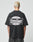 A person with short, bleached blonde hair is seen from behind wearing the LFDY Bulge Tee by LIVE FAST DIE YOUNG—an oversized black cotton T-shirt with bold front and back prints reading Everybody Eats Livefast in white and black.
