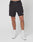 A model wears LIVE FAST DIE YOUNGs Live Fast Performance Shorts with a reflective LIVE FAST waistband, paired with white socks and sneakers, standing against a plain white background.