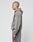A person with a shaved head stands in profile, wearing a loose gray LIVE FAST DIE YOUNG Basic Hooded Zip in a Leicht Cropped Fit with matching sweatpants and subtle logo print, set against a plain light background.