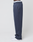 A person stands sideways against a plain white background wearing LIVE FAST DIE YOUNG LFDY Heavyweight Loungepants in navy blue, white sneakers, and underwear with "LIVE FAST" printed on the waistband.