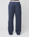 A person wears navy blue LFDY Heavyweight Loungepants by LIVE FAST DIE YOUNG, featuring a patch pocket on the right thigh, white sneakers, and a visible white LIV FAST waistband against a plain white background.