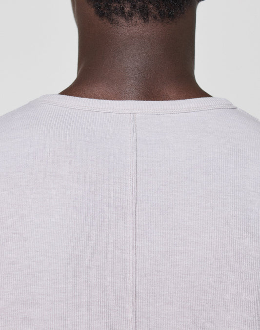 Close-up of the back neck and shoulders wearing the LFDY Rib Longsleeve by LIVE FAST DIE YOUNG—a light beige ribbed shirt featuring a central seam and subtle topstitching, set against a plain light background.