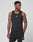 A man models the LIVE FAST DIE YOUNG Live Fast Performance Tank, a slim fit black sleeveless athletic top, with matching shorts, standing against a plain white background and looking to the side.