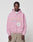A man faces the camera in a neutral pose, wearing the LIVE FAST DIE YOUNG LFDY Vandals Hooded Zip in light pink with a “Vandals Metro” front print, paired with beige pants, against a plain background.