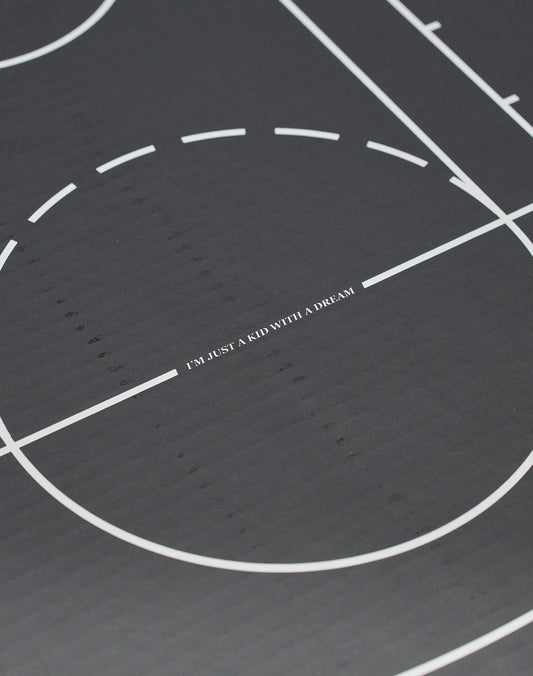 A close-up of a black Live Fast Basketball with white lines, LIVE FAST DIE YOUNG branding, and deep grooves, featuring IM JUST A KID WITH A DREAM at the center.
