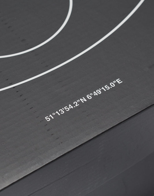 A close-up of the Live Fast Basketball by LIVE FAST DIE YOUNG shows its black surface with deep grooves, white concentric circles, printed coordinates—51°1354.2N 6°4915.0E—and subtle brand logo.