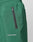 Close-up of Basic Shell Pants by LIVE FAST DIE YOUNG: green athletic pants with elastic waistband and drawstring, a black zippered pocket, and LIVE FAST in reflective white print near the pocket.