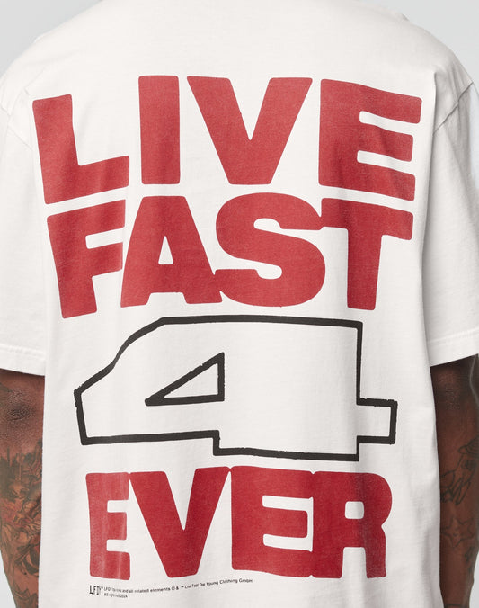 A person wears the LFDY 4 Ever Tee by LIVE FAST DIE YOUNG, an oversize white Baumwolle shirt with bold red LIVE FAST 4 EVER text and a large black-outlined number 4 printed on both front and back.