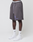 A person wearing LIVE FAST DIE YOUNG Live Fast LF Shorts in gray with a purple FAST graphic, elastic waistband, side pockets, white LEDY socks, and white sneakers stands against a plain white background.