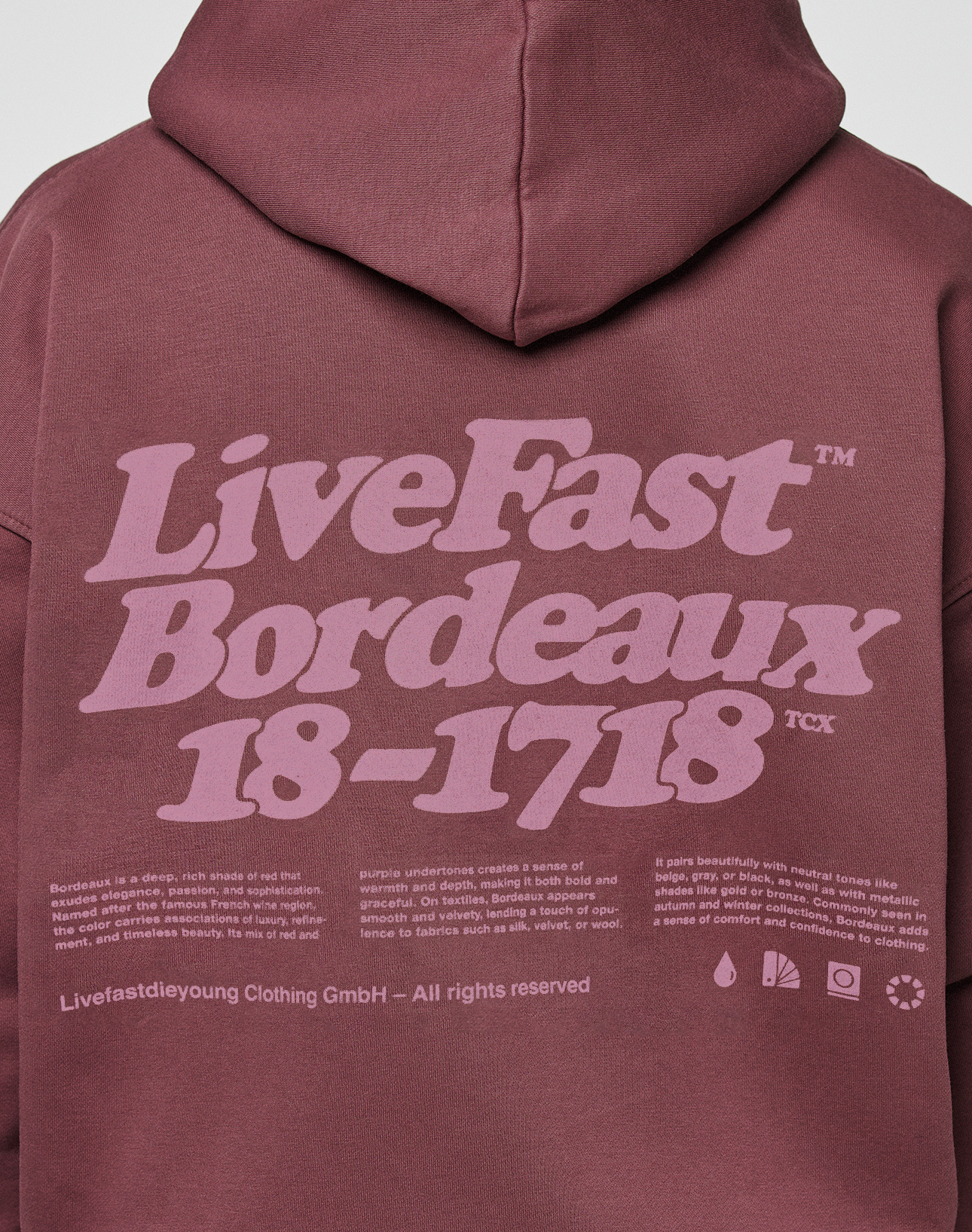 The Basic 360 Hooded by LIVE FAST DIE YOUNG is a maroon oversize fit cotton hoodie with a light purple front and back print: “LiveFast Bordeaux 18-1718,” plus small text blocks and icons with brand info at the bottom.