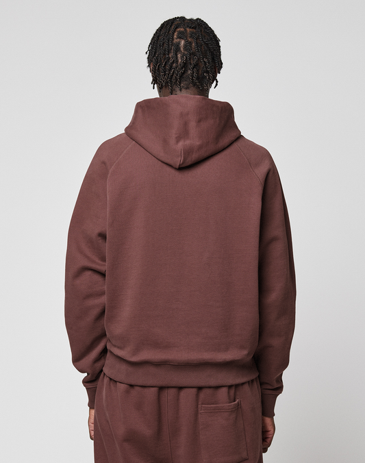 Seen from behind, a person with short, twisted hair wears the LIVE FAST DIE YOUNG LFDY Embroidery Hooded in brown with matching pants, both made from soft French Terry, set against a plain light gray background.