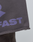 A close-up of the LIVE FAST DIE YOUNG Live Fast LF Shorts in dark gray shows purple "FAST" text, visible edge stitching, and a comfy Elastikbund waistband for extra ease.