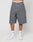 Someone stands against a plain light background wearing LFDY Jorts by LIVE FAST DIE YOUNG—long, baggy gray denim shorts with wide straight legs. Theyre styled with white socks, white sneakers, and underwear showing a visible LIVE FAST waistband.