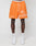 Wearing LIVE FAST DIE YOUNGs LFDY Praying Mesh Shorts in orange, featuring a regular fit, praying hands graphic, cross, and Live Fast text. Made from polyester with an elastic waistband. Paired with white socks and sneakers.