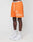 A person wearing LIVE FAST DIE YOUNG LFDY Praying Mesh Shorts in orange with white graphics, white socks, and Nike Air Force 1 sneakers stands against a plain white background. Only the lower half of the body is visible.