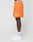 A person stands sideways wearing orange LFDY Praying Mesh Shorts by LIVE FAST DIE YOUNG, featuring white graffiti-style text, a drawstring, and an elastic waistband reading LIVE FAST. They pair them with white LFDY socks and white Nike sneakers.