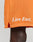A close-up of a person wearing LFDY Praying Mesh Shorts by LIVE FAST DIE YOUNG, featuring a comfy elastic waistband and Live Fast. in white near the hem. The regular fit orange shorts partially reveal the persons dark-skinned leg.